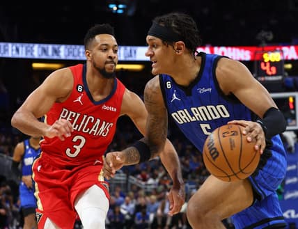 Jan 20, 2023; Orlando, Florida, USA; Orlando Magic forward Paolo Banchero (5) drives to the basket as New Orleans Pelicans guard CJ McCollum (3) defends during the second quarter at Amway Center. Mandatory Credit: Kim Klement-USA TODAY Sports