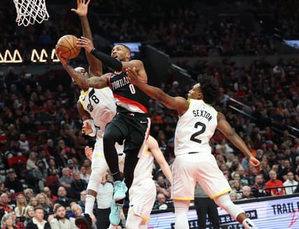 Jan 25, 2023; Portland, Oregon, USA; Portland Trail Blazers guard Damian Lillard (0) shoots over Utah Jazz forward Jarred Vanderbilt (8) and guard Collin Sexton (2) in the second half at Moda Center. Mandatory Credit: Jaime Valdez-USA TODAY Sports