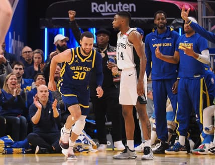 Mar 31, 2023; San Francisco, California, USA; Golden State Warriors guard Stephen Curry (30) smiles as he returns to defense after scoring a three point basket against the San Antonio Spurs during the second quarter at Chase Center. Mandatory Credit: Kelley L Cox-USA TODAY Sports