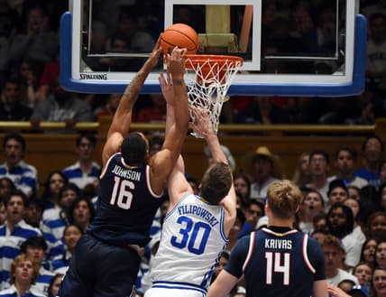 Nov 10, 2023; Durham, North Carolina, USA;  Arizona Wildcats forward Keshad Johnson (16) tips the ball into the basket in front of Duke Blue Devils center Kyle Filipowski(30)during the second half at Cameron Indoor Stadium. Mandatory Credit: Rob Kinnan-USA TODAY Sports