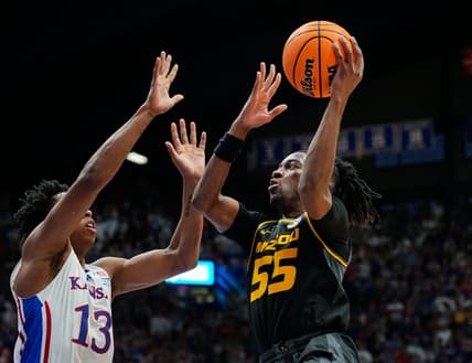 Dec 9, 2023; Lawrence, Kansas, USA; Missouri Tigers guard Sean East II (55) shoots against Kansas Jayhawks guard Elmarko Jackson (13) during the first half at Allen Fieldhouse. Mandatory Credit: Jay Biggerstaff-USA TODAY Sports