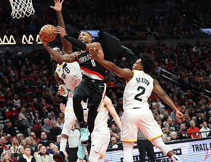 Jan 25, 2023; Portland, Oregon, USA; Portland Trail Blazers guard Damian Lillard (0) shoots over Utah Jazz forward Jarred Vanderbilt (8) and guard Collin Sexton (2) in the second half at Moda Center. Mandatory Credit: Jaime Valdez-USA TODAY Sports