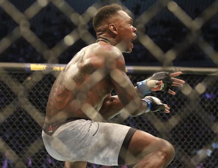 Oct 5, 2019; Melbourne, AUSTRALIA; Israel Adesanya (blue gloves) defeats Robert Whittaker (red gloves) during UFC 243 at Marvel Stadium. Mandatory Credit: Jasmin Frank-USA TODAY Sports