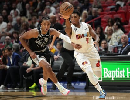 Dec 10, 2022; Miami, Florida, USA; Miami Heat guard Kyle Lowry (7) passes the ball as San Antonio Spurs guard Romeo Langford (35) follows on the play during the first half at FTX Arena. Mandatory Credit: Jim Rassol-USA TODAY Sports