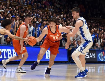 Jan 27, 2024; Durham, North Carolina, USA; Clemson Tigers center PJ Hall (24) drives to the basket as Duke Blue Devils center Kyle Filipowski (30) and guard Tyrese Proctor (5) defend during the first half at Cameron Indoor Stadium. Mandatory Credit: Rob Kinnan-USA TODAY Sports