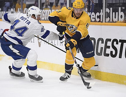 Feb 9, 2021; Nashville, Tennessee, USA;  Nashville Predators center Sean Malone (43) skates past Tampa Bay Lightning defenseman Jan Rutta (44) during the first period at Bridgestone Arena. Mandatory Credit: Steve Roberts-USA TODAY Sports