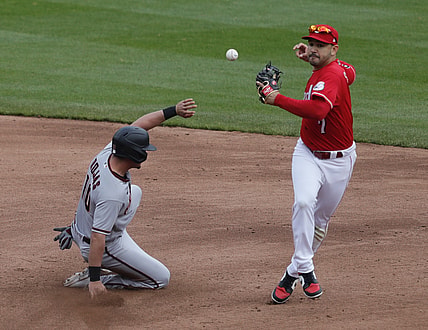 Apr 22, 2021; Cincinnati, Ohio, USA; Arizona Diamondbacks right fielder Josh Rojas (10) is safe at second against Cincinnati Reds shortstop Eugenio Suarez (7) during the third inning at Great American Ball Park. Mandatory Credit: David Kohl-USA TODAY Sports
