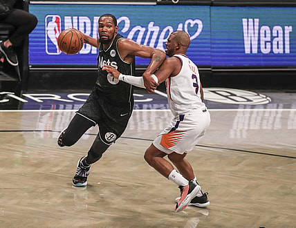 Apr 25, 2021; Brooklyn, New York, USA; Brooklyn Nets forward Kevin Durant (7) drives past Phoenix Suns guard Chris Paul (3) in the third quarter at Barclays Center. Mandatory Credit: Wendell Cruz-USA TODAY Sports