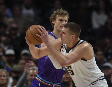 Oct 28, 2022; Denver, Colorado, USA; Utah Jazz forward Lauri Markkanen (23) defends against Denver Nuggets center Nikola Jokic (15) during the first quarter at Ball Arena. Mandatory Credit: John Leyba-USA TODAY Sports