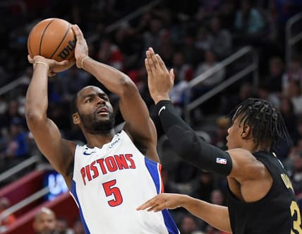 Nov 27, 2022; Detroit, Michigan, USA; Detroit Pistons guard Alec Burks (5) puts up shot over Cleveland Cavaliers guard Isaac Okoro (35) in the third quarter at Little Caesars Arena. Mandatory Credit: Lon Horwedel-USA TODAY Sports