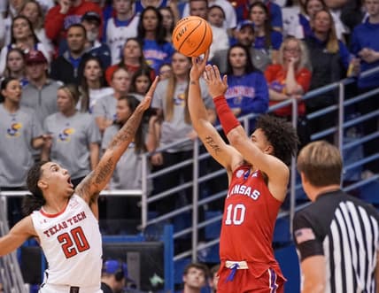 Feb 28, 2023; Lawrence, Kansas, USA; Kansas Jayhawks forward Jalen Wilson (10) shoots as Texas Tech Red Raiders guard Jaylon Tyson (20) defends during the first half at Allen Fieldhouse. Mandatory Credit: Denny Medley-USA TODAY Sports