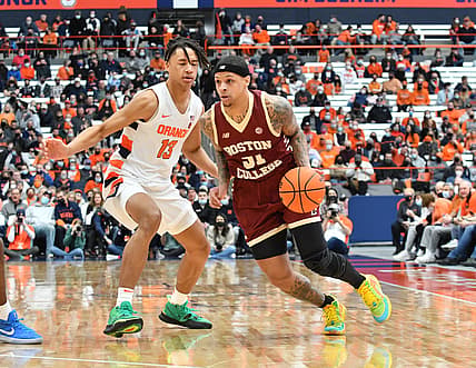 Feb 19, 2022; Syracuse, New York, USA; Boston College Eagles guard Brevin Galloway (51) tries to move the ball past Syracuse Orange forward Benny Williams (13) in the first half at the Carrier Dome. Mandatory Credit: Mark Konezny-USA TODAY Sports