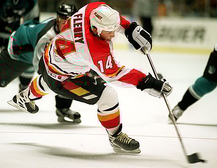 Calgary Flames forward Theoren Fleury shots the pu