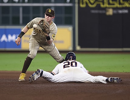 May 29, 2021; Houston, Texas, USA; Houston Astros left fielder Chas McCormick (20) slides into second base safely with a stolen base ahead of the throw to San Diego Padres second baseman Jake Cronenworth (left) during the fourth inning at Minute Maid Park. Mandatory Credit: Troy Taormina-USA TODAY Sports