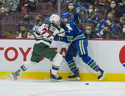 Oct 26, 2021; Vancouver, British Columbia, CAN; Minnesota Wild forward Nick Bjugstad (27) checks Vancouver Canucks forward J.T. Miller (9) in the first period at Rogers Arena. Mandatory Credit: Bob Frid-USA TODAY Sports