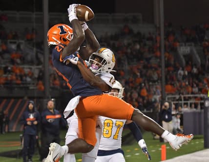 Sep 22, 2022; Champaign, Illinois, USA; Illinois Fighting Illini defensive back Jartavius Martin (21) intercepts the ball in the end zone on a pass intended for Chattanooga Mocs wide receiver Tyron Arnett (13) during the first half at Memorial Stadium. Mandatory Credit: Ron Johnson-USA TODAY Sports