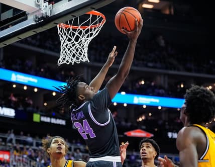 Dec 21, 2023; Kansas City, Missouri, USA; Kansas State Wildcats forward Arthur Kaluma (24) shoots against Wichita State Shockers forward Kenny Pohto (11) during the first half at T-Mobile Center. Mandatory Credit: Jay Biggerstaff-USA TODAY Sports