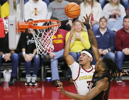 Iowa State Cyclones guard Tamin Lipsey (3) lays up the ball around Houston Cougars forward Joseph Tugler (25) during the second half in the Big-12 conference showdown of an NCAA college basketball at Hilton Coliseum on Tuesday, Jan. 9, 2024, in Ames, Iowa.