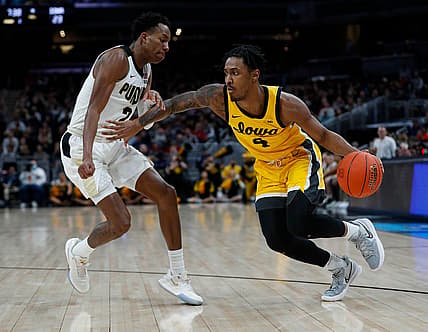 Purdue Boilermakers guard Eric Hunter Jr. (2) guards Iowa Hawkeyes guard Ahron Ulis (4) as he drives toward the basket during the first half of the Big Ten men's championship game on Sunday, March 13, 2022, at Gainbridge Fieldhouse in Indianapolis.

Iowa Hawkeyes Versus Purdue Boilermakers In Big Ten Men S Championship Title Game On Sunday March 13 2022 At Gainbridge Fieldhouse In Indianapolis