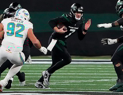 Nov 24, 2023; East Rutherford, New Jersey, USA; New York Jets quarterback Tim Boyle (7) scrambles against the Miami Dolphins in the second half at MetLife Stadium. Mandatory Credit: Robert Deutsch-USA TODAY Sports
