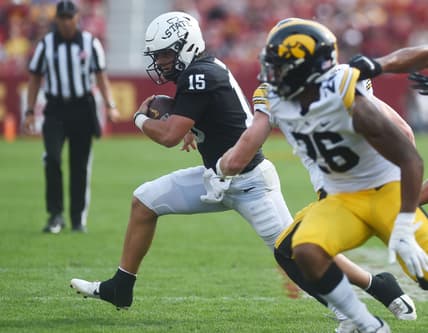 Iowa State's quarterback Brock Purdy runs with the ball around Iowa's defensive back Kaevon Merriweather during the first quarter in the Cy-Hawk series at Jack Trice Stadium Saturday, Sept. 11, 2021, in Ames, Iowa.