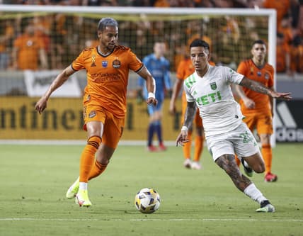 Sep 11, 2021; Houston, Texas, USA; Houston Dynamo FC forward Ariel Lassiter (11) advances the ball as Austin FC midfielder Sebastian Driussi (25) defends during the second half at BBVA Stadium. Mandatory Credit: Troy Taormina-USA TODAY Sports