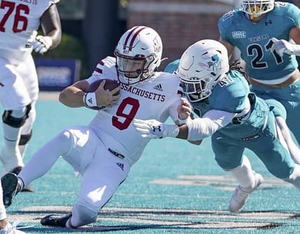 Sep 25, 2021; Conway, South Carolina, USA; Coastal Carolina Chanticleers linebacker Myles Olufemi (41) tackles Massachusetts Minutemen quarterback Garrett Dzuro (9)  in the NCAA football game of Massachusetts and Coastal Carolina at Brooks Stadium. Mandatory Credit: David Yeazell-USA TODAY Sports