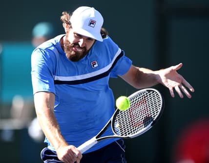 Oct 11, 2021; Indian Wells, CA, USA; Reilly Opelka (USA) hits a shot against Grigor Dimitrov (BUL) during his third round match in the BNP Paribas Open at the Indian Wells Tennis Garden. Mandatory Credit: Jayne Kamin-Oncea-USA TODAY Sports