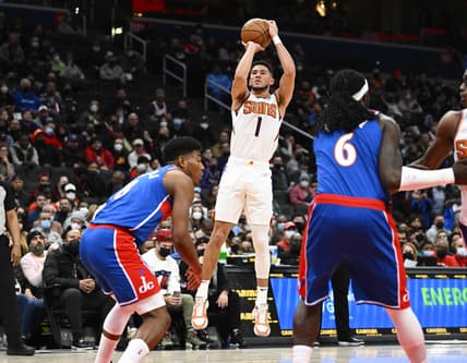 Feb 5, 2022; Washington, District of Columbia, USA; Phoenix Suns guard Devin Booker (1) shoots over Washington Wizards forward Rui Hachimura (8) and center Montrezl Harrell (6) during the first half at Capital One Arena. Mandatory Credit: Brad Mills-USA TODAY Sports