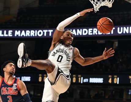 Feb 4, 2023; Nashville, Tennessee, USA; Vanderbilt Commodores guard Tyrin Lawrence (0) is fouled by Mississippi Rebels forward Myles Burns (3) during the first half at Memorial Gymnasium. Mandatory Credit: Christopher Hanewinckel-USA TODAY Sports