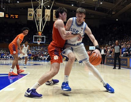 Jan 27, 2024; Durham, North Carolina, USA; Duke Blue Devils center Kyle Filipowski (30) controls the ball in front of Clemson Tigers center PJ Hall (24) during the second half at Cameron Indoor Stadium. Mandatory Credit: Rob Kinnan-USA TODAY Sports