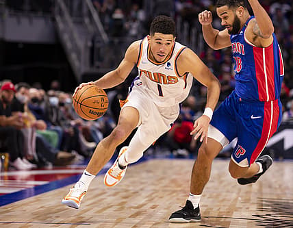 Jan 16, 2022; Detroit, Michigan, USA; Phoenix Suns guard Devin Booker (1) gets defended by Detroit Pistons guard Cory Joseph (18) during the third quarter at Little Caesars Arena. Mandatory Credit: Raj Mehta-USA TODAY Sports