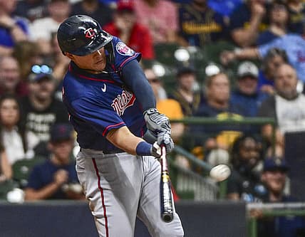Jul 26, 2022; Milwaukee, Wisconsin, USA; Minnesota Twins third baseman Gio Urshela (15) hits a three run home run in the fifth inning against the Milwaukee Brewers at American Family Field. Mandatory Credit: Benny Sieu-USA TODAY Sports