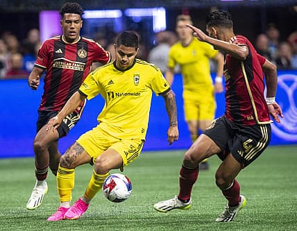 Oct 7, 2023; Atlanta, Georgia, USA;  Columbus Crew forward Cucho Hernandez (9) drives against Atlanta United defender Caleb Wiley (26) and defender Luis Abram (4) at Mercedes-Benz Stadium. Mandatory Credit: Julie Bennett-USA TODAY Sports