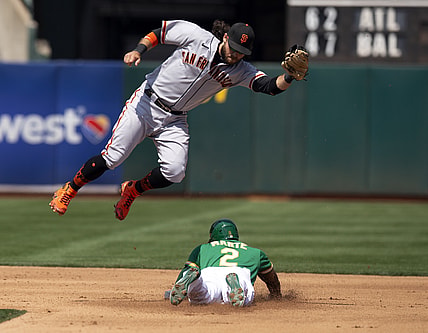 Aug 22, 2021; Oakland, California, USA; Oakland Athletics center fielder Starling Marte (2) slides safely into second with a stolen base as San Francisco Giants shortstop Brandon Crawford (35) has to leave his feet to corral the relay during the fourth inning at RingCentral Coliseum. Mandatory Credit: D. Ross Cameron-USA TODAY Sports