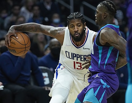 Nov 7, 2021; Los Angeles, California, USA; LA Clippers guard Paul George (13) drives the baseline defended by Charlotte Hornets guard Terry Rozier (3) in the second quarter at Staples Center. Mandatory Credit: Robert Hanashiro-USA TODAY Sports