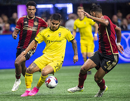 Oct 7, 2023; Atlanta, Georgia, USA;  Columbus Crew forward Cucho Hernandez (9) drives against Atlanta United defender Caleb Wiley (26) and defender Luis Abram (4) at Mercedes-Benz Stadium. Mandatory Credit: Julie Bennett-USA TODAY Sports