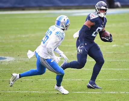 Dec 20, 2020; Nashville, Tennessee, USA; Tennessee Titans tight end Jonnu Smith (81) runs after a catch before being hit by Detroit Lions strong safety Duron Harmon (26) during the first half at Nissan Stadium. Mandatory Credit: Christopher Hanewinckel-USA TODAY Sports