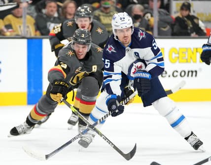 Jan 2, 2022; Las Vegas, Nevada, USA; Vegas Golden Knights defenseman Brayden McNabb (3) reaches to poke the puck away from Winnipeg Jets center Mark Scheifele (55) during the third period at T-Mobile Arena. Mandatory Credit: Stephen R. Sylvanie-USA TODAY Sports