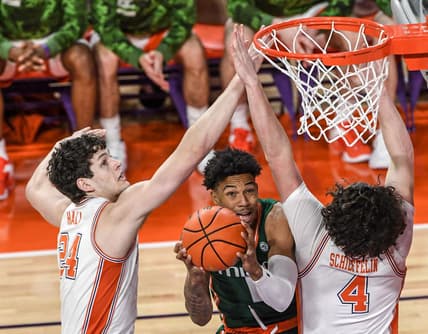 Feb 4, 2023; Clemson, South Carolina, USA; Miami guard Jordan Miller (11) shoots around Clemson sophomore forward PJ Hall (24) and Clemson sophomore forward Ian Schieffelin (4) during the first half at Littlejohn Coliseum in Clemson, S.C. Saturday, Feb. 4, 2023.  Mandatory Credit: Ken Ruinard-USA TODAY Sports