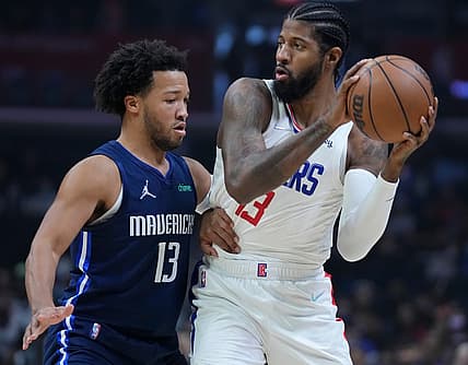 Nov 21, 2021; Los Angeles, California, USA; LA Clippers guard Paul George (13) defended by Dallas Mavericks guard Jalen Brunson (13) in the first quarter at Staples Center. Mandatory Credit: Robert Hanashiro-USA TODAY Sports