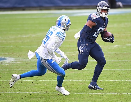 Dec 20, 2020; Nashville, Tennessee, USA; Tennessee Titans tight end Jonnu Smith (81) runs after a catch before being hit by Detroit Lions strong safety Duron Harmon (26) during the first half at Nissan Stadium. Mandatory Credit: Christopher Hanewinckel-USA TODAY Sports