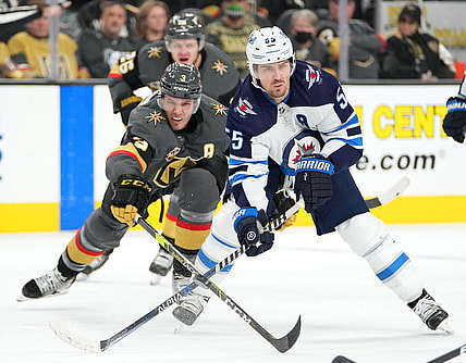 Jan 2, 2022; Las Vegas, Nevada, USA; Vegas Golden Knights defenseman Brayden McNabb (3) reaches to poke the puck away from Winnipeg Jets center Mark Scheifele (55) during the third period at T-Mobile Arena. Mandatory Credit: Stephen R. Sylvanie-USA TODAY Sports
