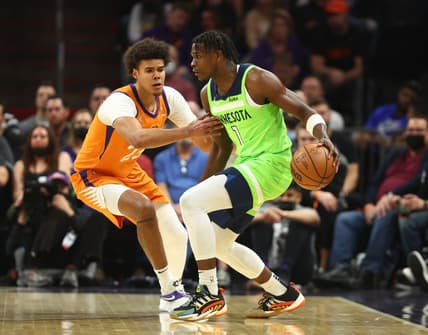 Jan 28, 2022; Phoenix, Arizona, USA; Minnesota Timberwolves forward Anthony Edwards (1) controls the ball against Phoenix Suns forward Cameron Johnson (23) in the first half at Footprint Center. Mandatory Credit: Mark J. Rebilas-USA TODAY Sports