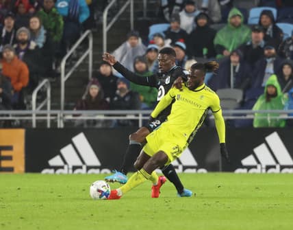 Mar 5, 2022; Saint Paul, Minnesota, USA; Minnesota United defender Bakaye Dibassy (12) and Nashville SC forward C.J. Sapong (17) fight for the ball in the first half at Allianz Field. Mandatory Credit: Matt Krohn-USA TODAY Sports