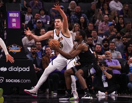 Mar 9, 2022; Sacramento, California, USA; Sacramento Kings forward Harrison Barnes (40) looks to pass the ball against Denver Nuggets center Nikola Jokic (15) during the second quarter at Golden 1 Center. Mandatory Credit: Kelley L Cox-USA TODAY Sports