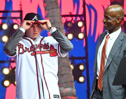 Jul 17, 2022; Los Angeles, CA, USA;  Former Atlanta Braves player Fred McGriff presents JR Ritchie right with his jersey after he was selected by the Atlanta Braves as the 35th pick of the MLB draft at XBox Plaza at LA Live. Mandatory Credit: Jayne Kamin-Oncea-USA TODAY Sports