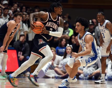 Nov 10, 2023; Durham, North Carolina, USA;  Arizona Wildcats guard Caleb Love (2) drives to the basket as Duke Blue Devils guard Jared McCain (0) defends during the second half at Cameron Indoor Stadium. Mandatory Credit: Rob Kinnan-USA TODAY Sports