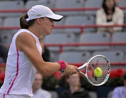 Aug 11, 2023; Montreal, Quebec, Canada; Iga Swiatek (POL) hits a backhand against Danielle Collins (USA) (not pictured) during quarterfinal play at IGA Stadium. Mandatory Credit: Eric Bolte-USA TODAY Sports