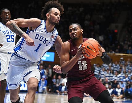 Dec 10, 2022; Durham, North Carolina, USA; Maryland Eastern Shore Eagles forward Nathaniel Pollard Jr. (12) drives to the basket as Duke Blue Devils center Dereck Lively (1) defends during the first half at Cameron Indoor Stadium. Mandatory Credit: Rob Kinnan-USA TODAY Sports